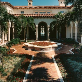A long axial view through a series of courtyards in a Palm Beach Estate