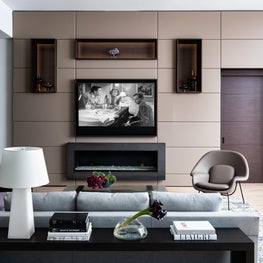 Modern Family Room with Lighted Cabinetry