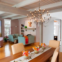 Lake Michigan Great Room. Post and Beam Great Room with 2097 chandelier, lighthouse painting & sunrise color scheme.