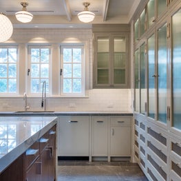 A mix of classical and modern details with an apothecary style display cabinet