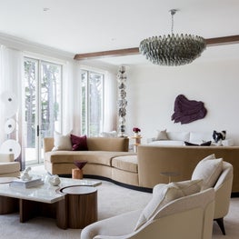 Portfolio: A tan-colored serpentine sofa centers a modern living room in Pebble Beach, CA.