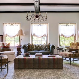 Living room with textural layers from Faux Bois rug to vintage Chesterfield sofa