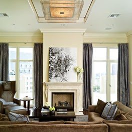 This interior blends multiple seating areas, contemporary furniture and a restrained color palette creating a backdrop for relaxing at home or entertaining friends with various activities.