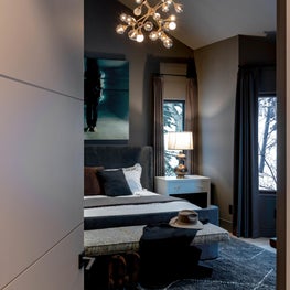 Beautiful, moody hues envelop the primary bedroom of Mountain Lane creating the perfect cozy retreat.