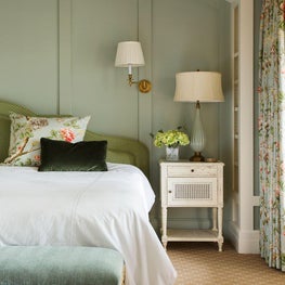 Pistachio wood paneling above master bed