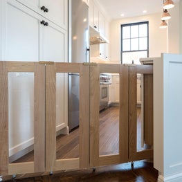 Open White Kitchen with a Custom Pet Gate