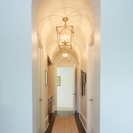 Arched hallway with repeating brass lanterns