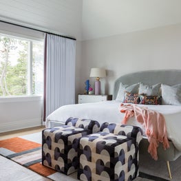 Portfolio: A guest bedroom in a home in Pebble Beach, CA with gray headboard and white bedding.