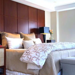 Elegant transitional master bedroom with custom headboard