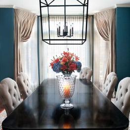 American Lodge Dining Room. Black dining table with pendant lantern, linen chairs, silk drapes & teal walls.