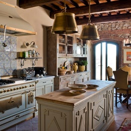 Reclaimed wood beams and stunning stone walls frame this craftsman kitchen