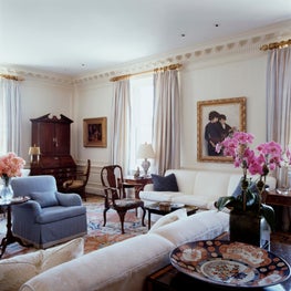 A completely renovated prewar livingroom with paneling and plaster cornices