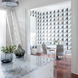 Kitchen and Dinette area features graphic wallpaper on accent wall for bold look