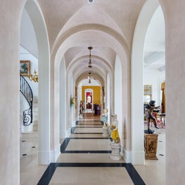 Classical motif limestone flooring in a groin vaulted Venetian plaster gallery
