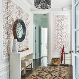 Transitional entry way with printed wallpaper and drum pendant