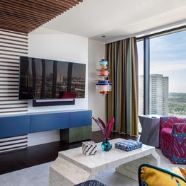 Portfolio: High-rise Living Room with an Abstract Wall Covering and Colorful Furniture