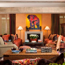 Orange plastered walls paired with original Warhol African Elephant.
