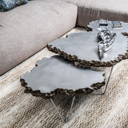 SLEEK CONTEMPORARY METALLIC RESIDENCE raw edge metal coffee table, neutral rug, beige sofa