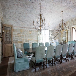 Brick ceiling dining room with antique French chandelier and reclaimed doors