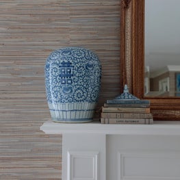 A classic coastal mix of variegated grasscloth and blue and white porcelain.