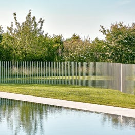 A sinuous, contemporary twist on a pool fence