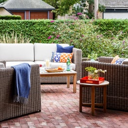 Brick patio with Kingsley Bate wicker- design by Sophia Shibles