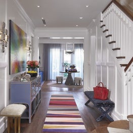Entry hallway featuring colorful designer pieces and accents