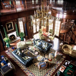 Formal walnut library with grand chandelier.