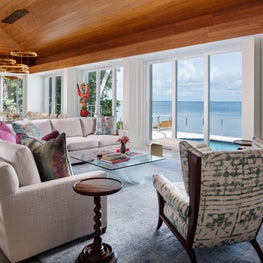 An uninterrupted view complemented by an eclectic neutral & blue seating area.