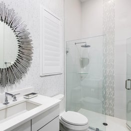 SLEEK CONTEMPORARY METALLIC RESIDENCE, metalic bathroom, silver sunburst mirror, inset tiled shower, white tile, gray tile, neutral bathroom