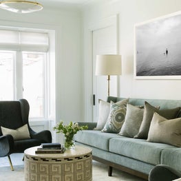 Clean transitional family room living area, mid-century chair and ethnic details