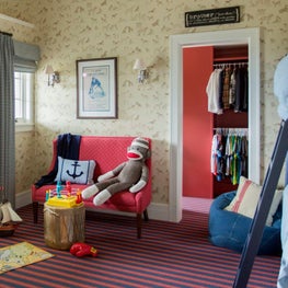 Kid's room with fun wallpaper and striped floors