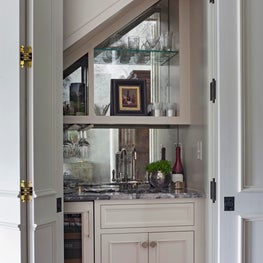 Elegant bar tucked under the stairs makes good use of this otherwise lost space