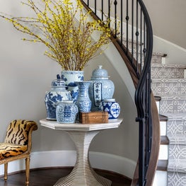 Formal entry hall & stairway with patterned runner & blue-and-white porcelain