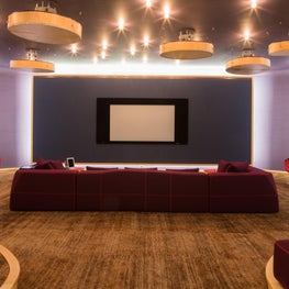 This plush modern media room has an abundance of hidden storage space.