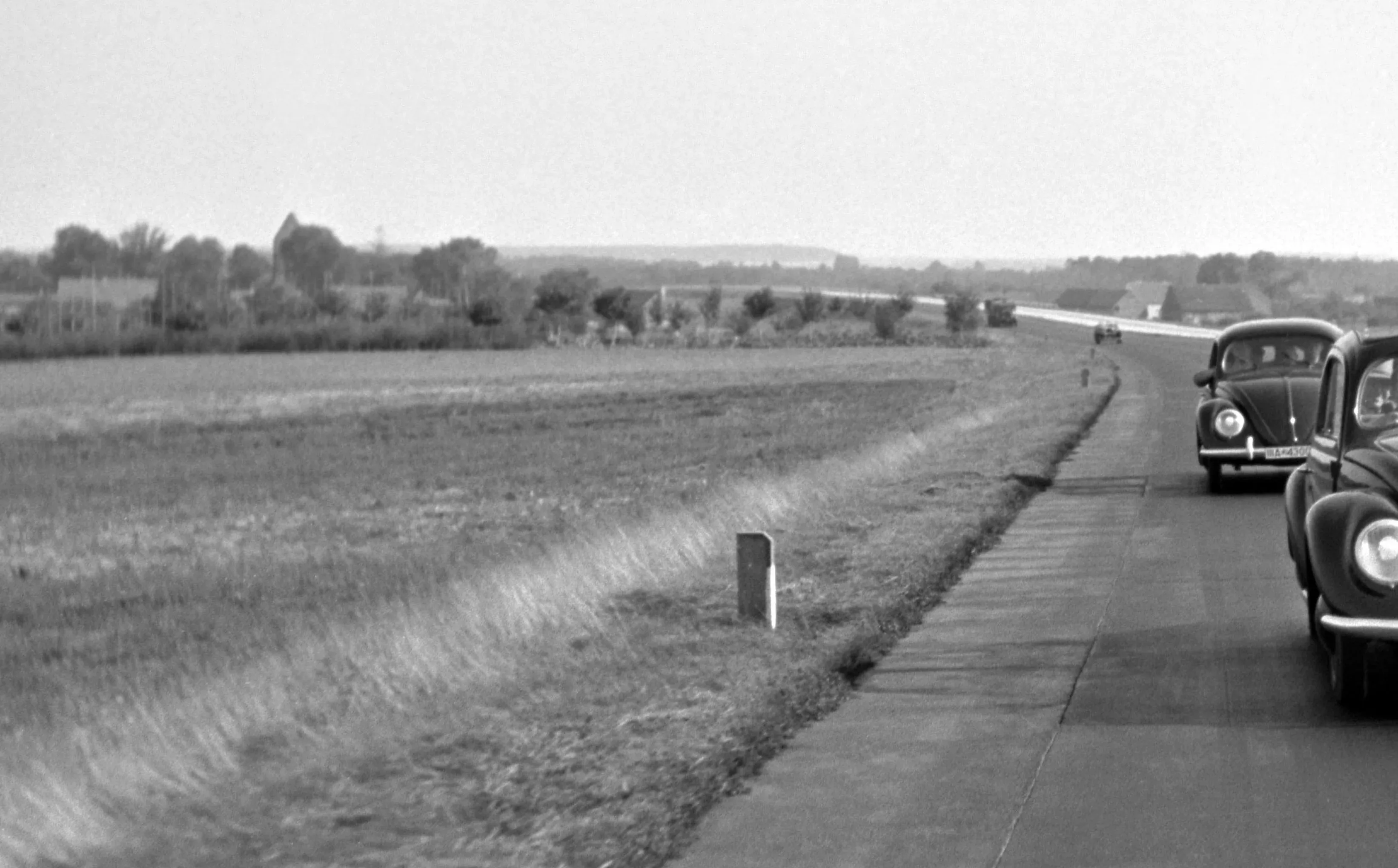 Two Volkswagen Beetles on the Highway, Germany, 1938 main image 0