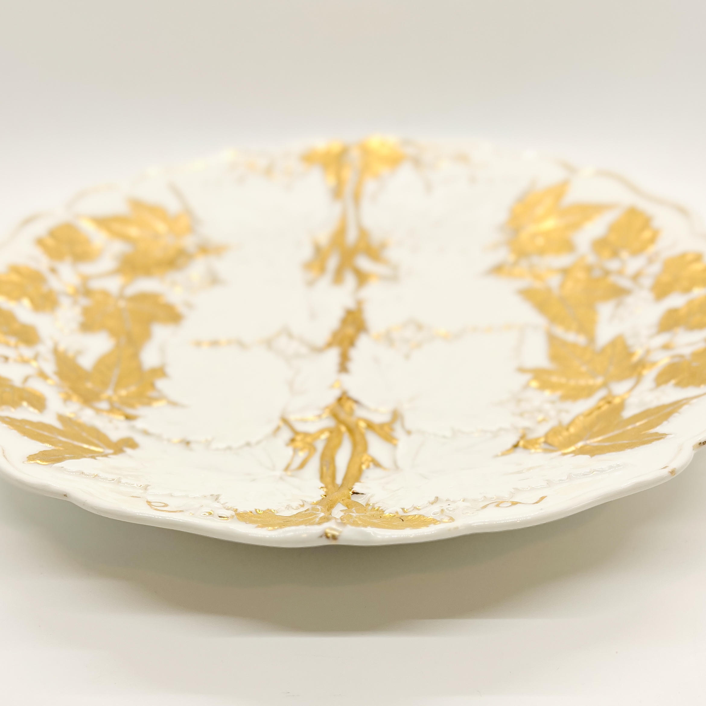 Porcelain Relief Plate with Gilt Moulded Vine and Grape Leaves