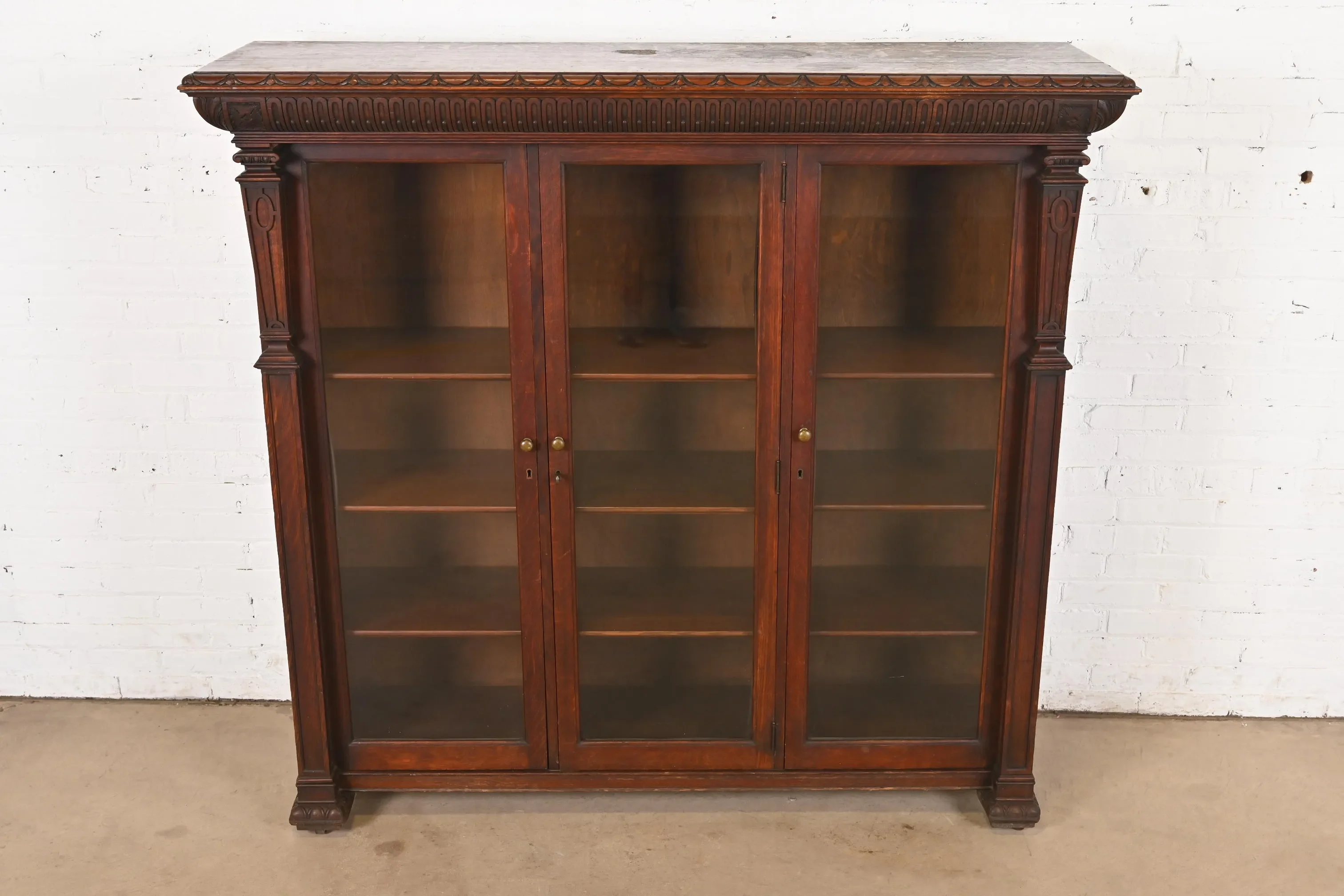 R. J. Horner Style American Empire Carved Oak Glass Front Triple