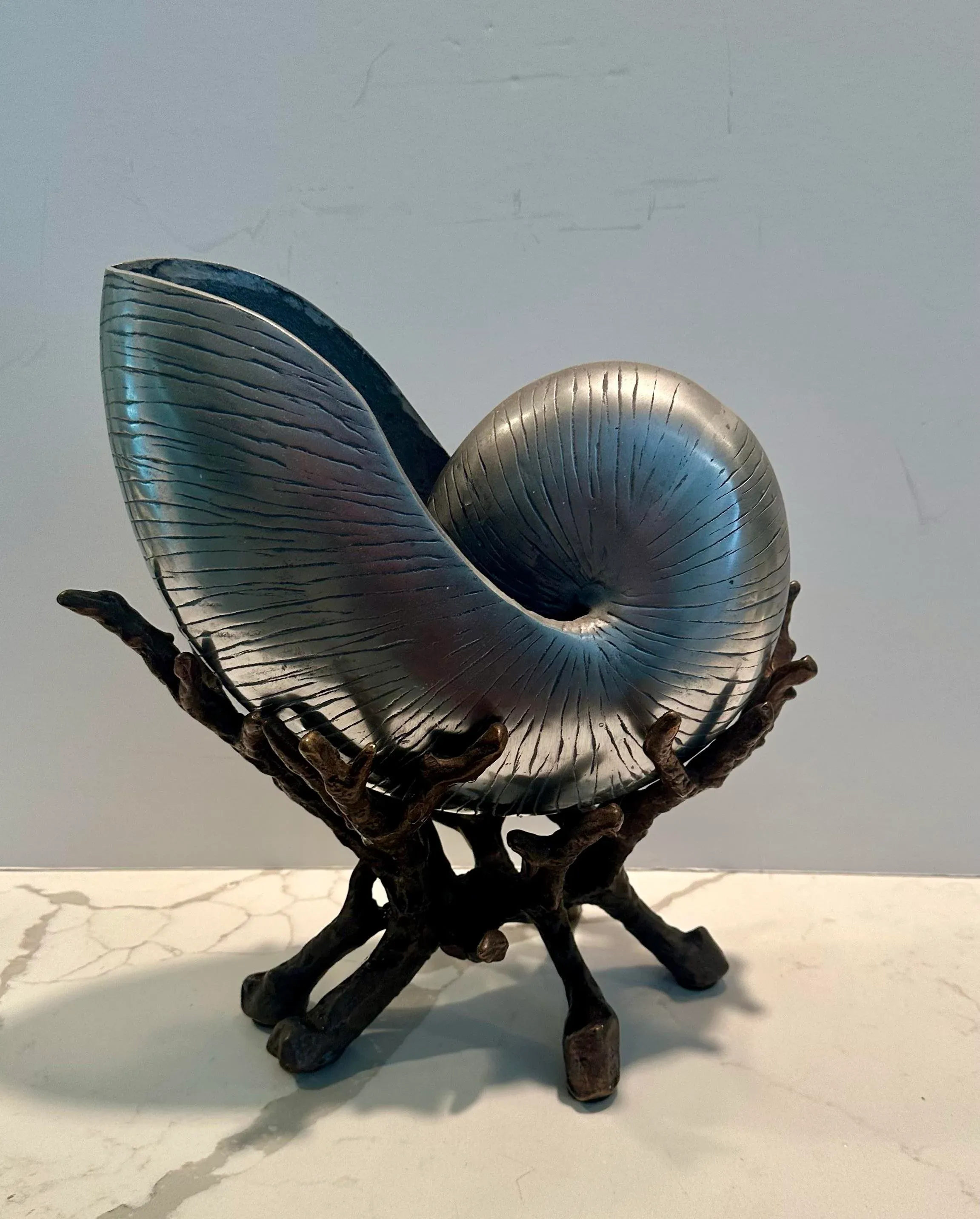 Cupid sitting astride a snail's shell,1920s silvered bronze