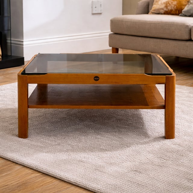 This Myer Mid-Century Modern Teak Coffee Table is a timeless piece that embodies classic 1960s design. Featuring a smoked...
