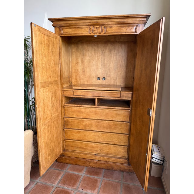 Exceptional custom-made media cabinet by Century Hill, crafted from solid wood with rich hand-carved detailing throughout....