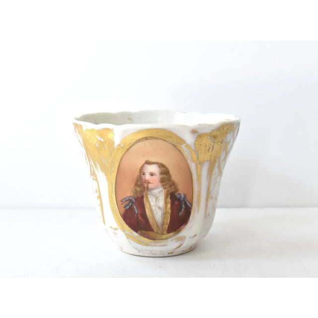 An antique, 19th-century, Old Paris Porcelain or "Porcelaine de Paris" mug, featuring a miniature portrait or a 17th-...