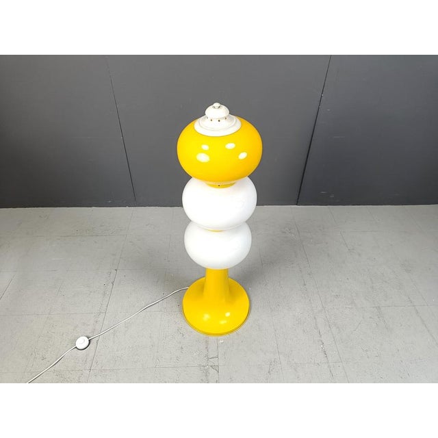 Striking mid century opaline shade floor lamp with a tulip shaped metal yellow base. Very cool design with two white...