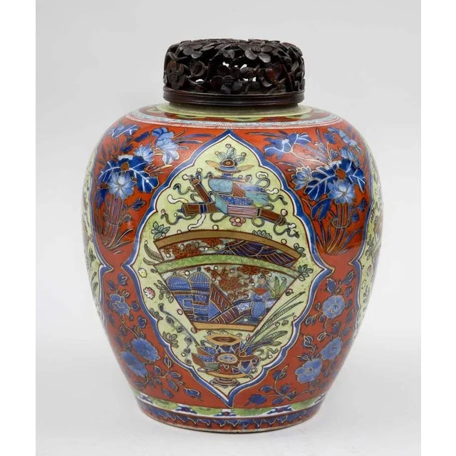 Rare and refined blue and white Kangxi “clobbered” jar with carved lid, very finely painted and parcel gilded in iron red,...