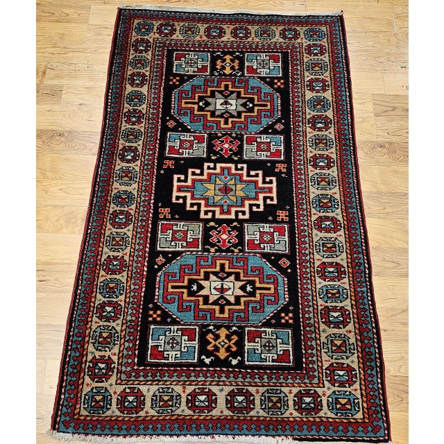 "This exceptional mid-20th century vintage Persian Kurdish area rug features a striking geometric medallion design...