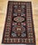 "This exceptional mid-20th century vintage Persian Kurdish area rug features a striking geometric medallion design...