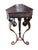Triangular top side table featuring a dark wood top with relief floral/rosette carved aprons, supported by a tripod...