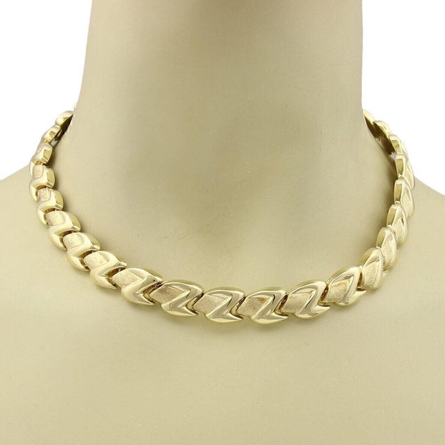 The Z Shape 14k Yellow Gold Fancy Textured Link Collar Necklace is a stylish and versatile piece of fine jewelry. This...