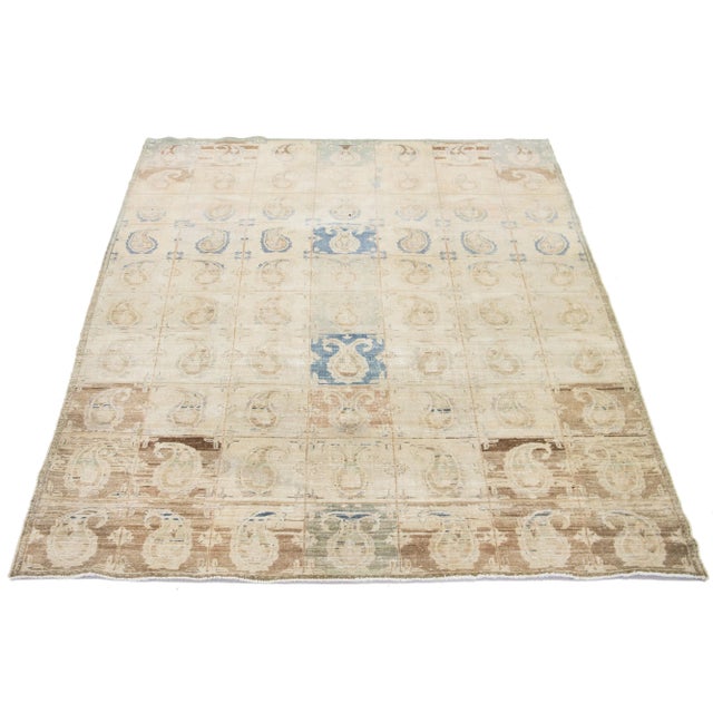 This beautifully handcrafted Persian Tabriz wool rug displays a classic all-over Boteh pattern. The beige background...