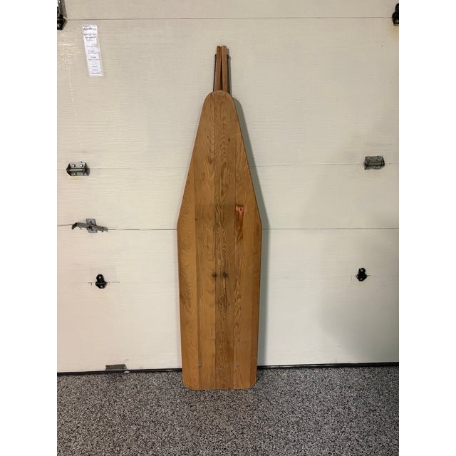 Bring authentic rustic charm to your home with this beautiful early-to-mid 20th-century folding wooden ironing board....